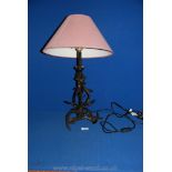 A metal table Lamp in the form of antlers, 18'' tall plus maroon shade.