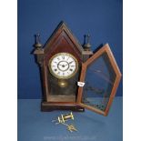 A Jerome wooden cased and glass fronted eight day mantle Clock with key,