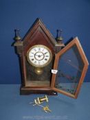 A Jerome wooden cased and glass fronted eight day mantle Clock with key,
