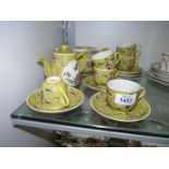 An oriental Teaset, yellow ground with ornate embossed scrolling and floral design,