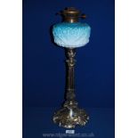A plated Oil Lamp with ombre blue glass oil reservoir on Corinthian column base decorated with