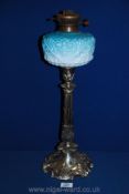 A plated Oil Lamp with ombre blue glass oil reservoir on Corinthian column base decorated with