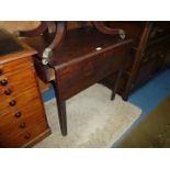 A 19th Century mahogany Pembroke table with single drawer on reeded bevelled legs with roller