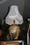 A large crackle glazed pale orange Table Lamp with flower and butterfly decoration, cream six shade,