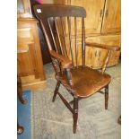 A solid Elm seated and other woods Kitchen elbow Chair having stick-back details and turned legs