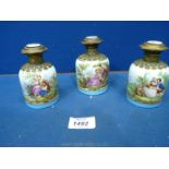 Three ormolu and ceramic scent Bottles; (hinge broken on one lid,
