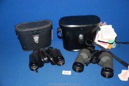 A pair of cased Boots Pacer 8 x 30 mm Binoculars together with a cased pair of Swift 10 x 40 mm