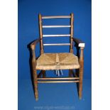 A mixed woods seagrass-seated Child's elbow Chair, 25 1/2'' high approx.