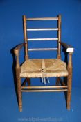 A mixed woods seagrass-seated Child's elbow Chair, 25 1/2'' high approx.