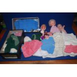 A large quantity of doll's clothes, plus small plastic dolls, etc.