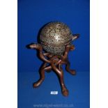 A wooden carved stand, 11 3/4'' tall with pierced metal Ball,