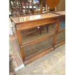 A two stage Oak Globe Wernicke type enclosed Bookcase,