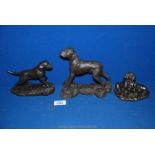 Three bronze coloured figures of dogs.