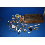 An Oak knife box containing miscellaneous items including bottle stoppers, AA badge,