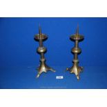 A pair of antique bell metal Gothic style pricket candlesticks. 12" high.