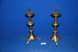 A pair of antique bell metal Gothic style pricket candlesticks. 12" high.