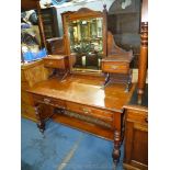 An Edwardian Mahogany dressing Table standing on turned legs united by a lower shelf and having two