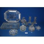 Two glass dressing table sets with candlesticks, lidded bowls etc.