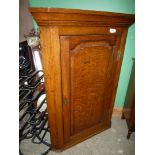 An 18th Century oak corner cupboard.