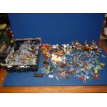 A large quantity of plastic cowboys and Indians, many not painted.