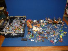 A large quantity of plastic cowboys and Indians, many not painted.