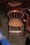 An appealing mixed woods circa 1900 child's High Chair having turned stretchers and legs and back