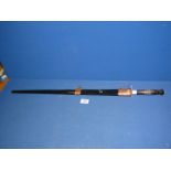 A reproduction sword with wooden handle and black sheath, 29 1/2" long.