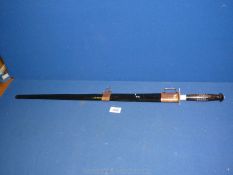 A reproduction sword with wooden handle and black sheath, 29 1/2" long.