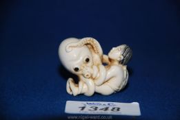 A good late Meiji ivory Netsuke depicting Ama and Tako, the girl pearl diver and the octopus,