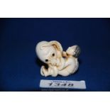 A good late Meiji ivory Netsuke depicting Ama and Tako, the girl pearl diver and the octopus,