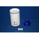 An Eirian glass Paperweight in the shape of a teardrop with blue swirls and bubbles, boxed.