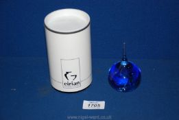 An Eirian glass Paperweight in the shape of a teardrop with blue swirls and bubbles, boxed.