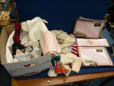 A quantity of linen including table mats,napkins, felt bag, tea cosy, boxed pillowcases etc.