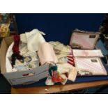 A quantity of linen including table mats,napkins, felt bag, tea cosy, boxed pillowcases etc.