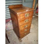 A stained Pine topped Oak Tallboy of five short drawers having military style brass recessed drop
