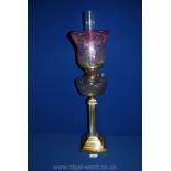 A Brass Oil Lamp, 18'' tall with pink shaded and etched glass shade,
