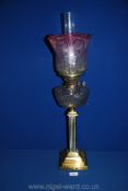 A Brass Oil Lamp, 18'' tall with pink shaded and etched glass shade,