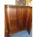 A gentleman's Mahogany Wardrobe having raised and fielded panelled doors revealing hanging space