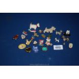 A collection of Scottie dog brooches and other lapel badges including Peter Rabbit, etc.
