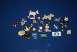 A collection of Scottie dog brooches and other lapel badges including Peter Rabbit, etc.