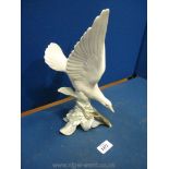 A Lladro figure of a white dove, 11 1/2" tall.