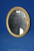 A brass Art Deco style standing mirror, having a lady to the side of the frame. 14" x 11".