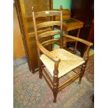 A good Oak ladder back open armed Elbow Chair having turned legs,