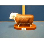 A Beswick horned Hereford Bull, on stand.