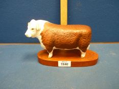 A Beswick horned Hereford Bull, on stand.