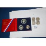 Four ten shilling coins Guernsey 1966 and 1776-1976 United States silver proof set.