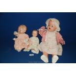 A 1950's Pedigree Doll, dressed in pink, 19'' tall, (crack to face) and two 1950's dolls, both a/f,