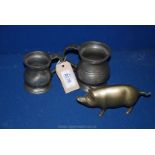 Two pewter tankards; 1/2 pint and 1/4 pint and a brass pig.
