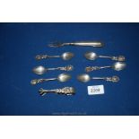 A set of continental silver teaspoons with flower handle, sugar tongs and fork,