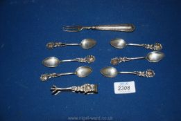 A set of continental silver teaspoons with flower handle, sugar tongs and fork,
